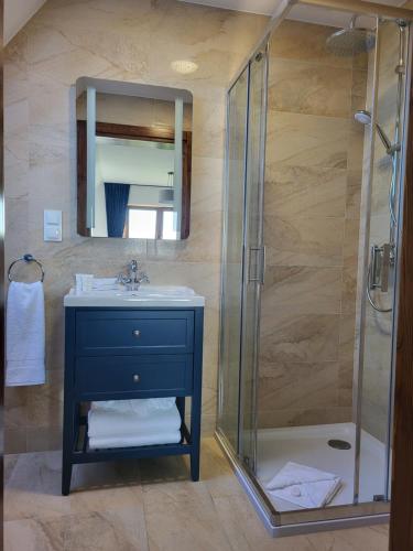 a bathroom with a sink and a shower at Gościniec Murzasichle in Murzasichle