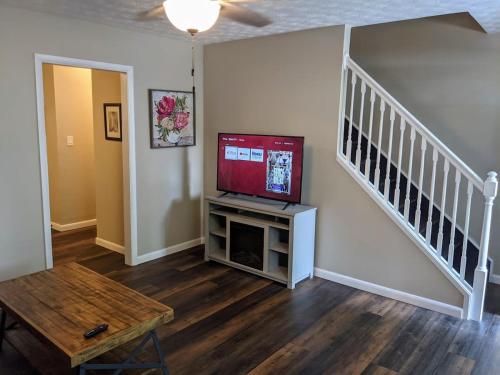 a living room with a flat screen tv on a entertainment center at Carter #5 Two bedroom unit near Xavier Downtown in Cincinnati