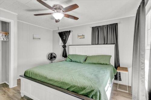 a bedroom with a bed with a ceiling fan at Stylish 4 bedroom home in Groves in Groves