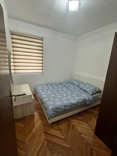 a bedroom with a bed and a wooden floor at Viktor in Gornje Mladice