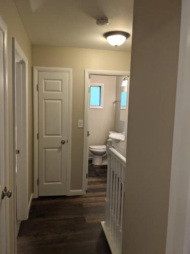 a hallway with a bathroom with a toilet and a door at Carter #5 Two bedroom unit near Xavier Downtown in Cincinnati