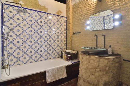a bathroom with a bath tub and a sink at Casa Tenorio Barrio de Santa Cruz in Seville