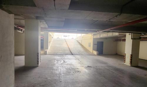 an empty parking lot in an empty parking garage at Two-Bedroom Luxury Apartment, Zameen Opal in Lahore