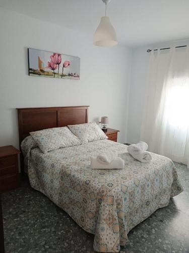 a bedroom with a bed with two towels on it at La casita del sillero in Jimena de la Frontera