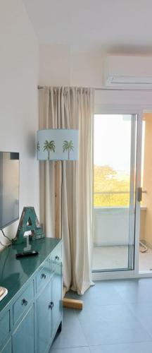 a bathroom with a dresser with a mirror and a window at Bellavista Punta Ala in Punta Ala