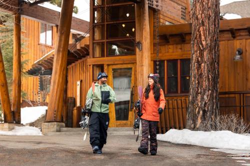 two people walking down a sidewalk in front of a building at Gravity Haus Truckee-Tahoe in Truckee