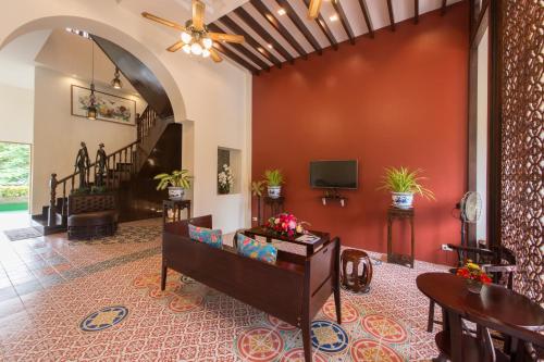 a living room with a red wall at O'nya Phuket Hotel - SHA Extra Plus in Phuket Town