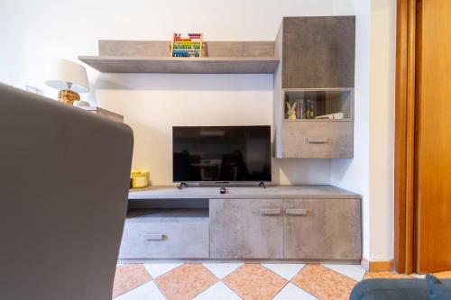a living room with a large entertainment center with a flat screen tv at Casa di Jennifer 3 in Parma