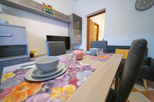 a dining room with a table with a table cloth on it at Casa di Jennifer 3 in Parma