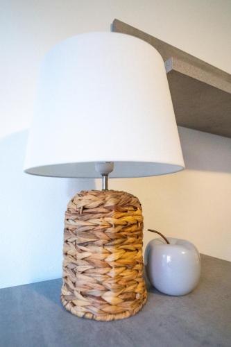 a lamp sitting on a table next to an apple at Casa di Jennifer 3 in Parma