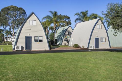 a large white building with a blue roof at Discovery Parks - Bunbury in Bunbury