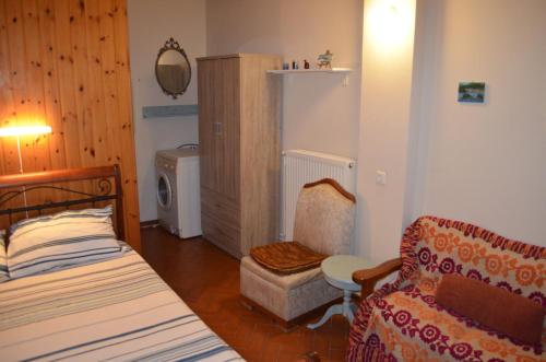a bedroom with a bed and a couch and a chair at Nick Apartment in Zakynthos Town