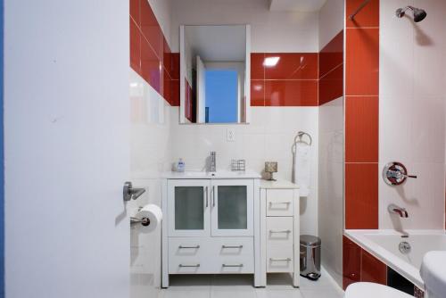 a white bathroom with a sink and a toilet at 24-10 Studio Prime Gramercy WD in Unit in New York