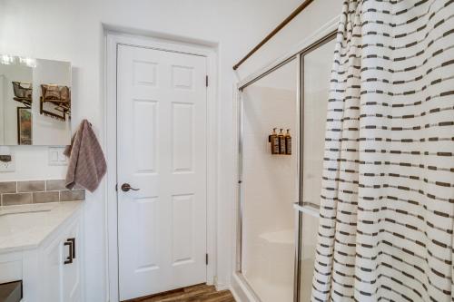 a bathroom with a shower and a white door at Mtn Views and Playground Family-Friendly Pine Cabin in Pine