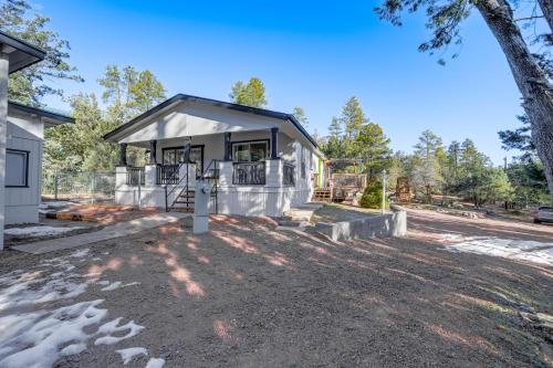 a home under construction with a porch and a tree at Mtn Views and Playground Family-Friendly Pine Cabin in Pine