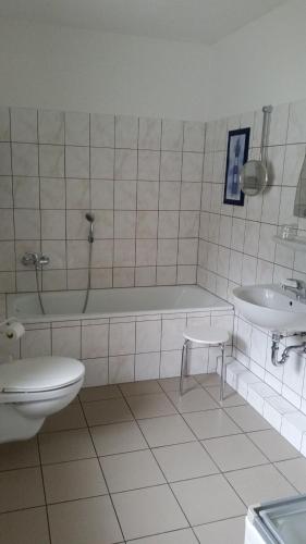 La salle de bains est pourvue d'une baignoire, de toilettes et d'un lavabo. dans l'établissement Villa Sophienhöhe, à Kerpen