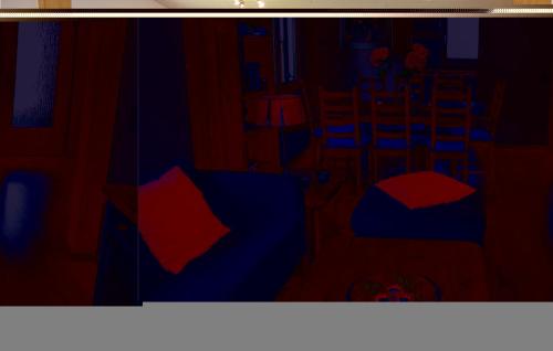 a dark room with red and blue furniture in it at Ferienhaus 15 In Kirchheim in Kirchheim