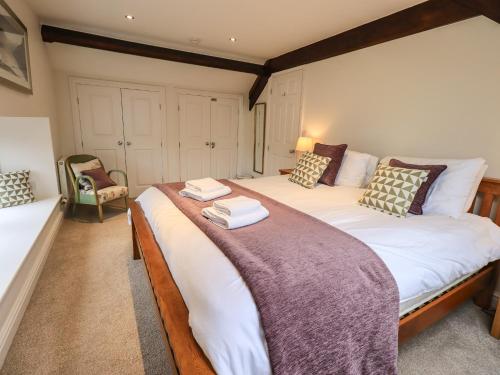 a bedroom with a large bed with two towels on it at Middlerigg in Ambleside