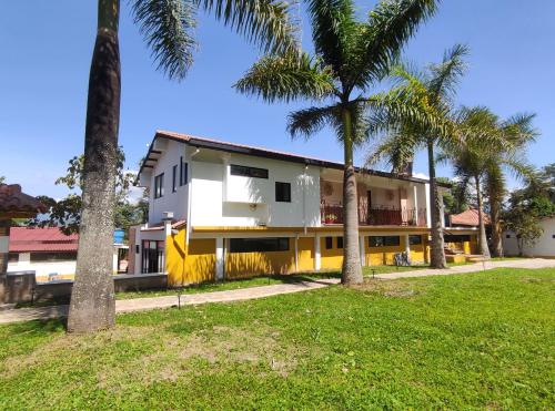 a building with palm trees in front of it at La Cabaña Miraflores in Miraflores