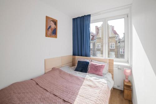 a bedroom with a bed and a window at Grobla -Old Town by Grand Apartments in Gdańsk