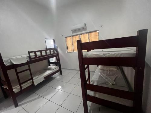 a room with two bunk beds and a window at POUSADA MARINHA DO CEU in Maceió