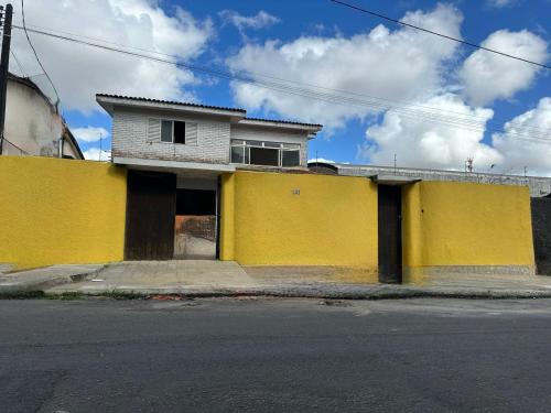 a yellow building on the side of a street at POUSADA MARINHA DO CEU in Maceió