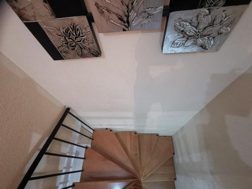 a staircase with paintings on the wall and a stair case at Apartamento en la playa de Oropesa in Oropesa del Mar