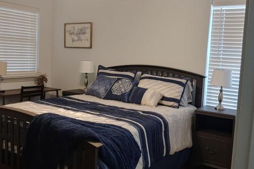 a bedroom with a bed with blue and white blankets and pillows at Relax and Unwind in Bryan