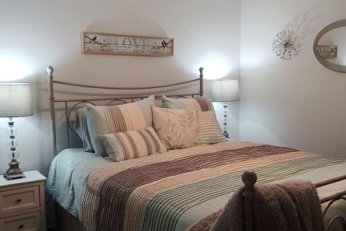 a bedroom with a bed with pillows and a mirror at Relax and Unwind in Bryan