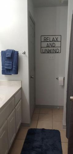 a bathroom with a sink and a blue rug at Relax and Unwind in Bryan