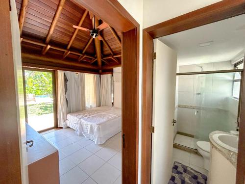 a bedroom with a bed and a bathroom at Ecco Village - Serrambi in Porto De Galinhas
