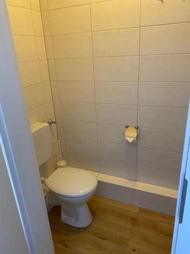 a bathroom with a toilet and a roll of toilet paper at Pension Feist Zimmer4 in Dagebüll