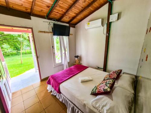 a bedroom with a bed and a window at CENTRO RECREACIONAL DEL SAN JUAN in San Juan de Urabá