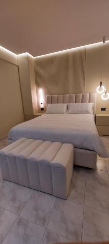 a bedroom with a large bed with a white bedvisor at Lungofiume Suite in Avellino