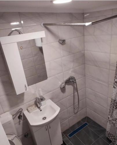a bathroom with a sink and a shower at City River View in Foča