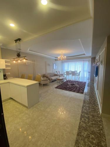 a living room with a kitchen and a dining room at Baku - Park Azure with sea view two bedrooms and one living room in Baku