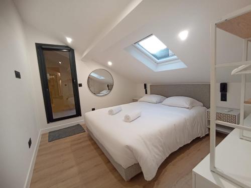 a bedroom with a white bed and a mirror at Monte Carlo Monaco Border - luxury, modern, cozy with home feelings and See View in Beausoleil