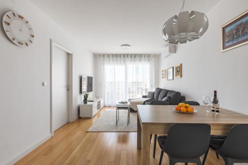 a living room with a table and a couch at Diva apartment with free private parking in Split