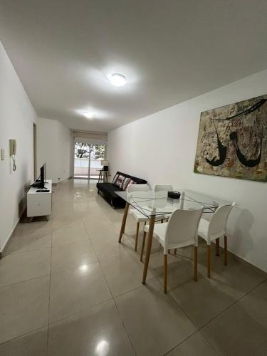 a living room with a glass table and chairs at Mairea II, Nueva Cordoba in Córdoba