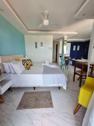 a bedroom with a bed and a living room at Hotel Aconchego Da Vila in Saquarema