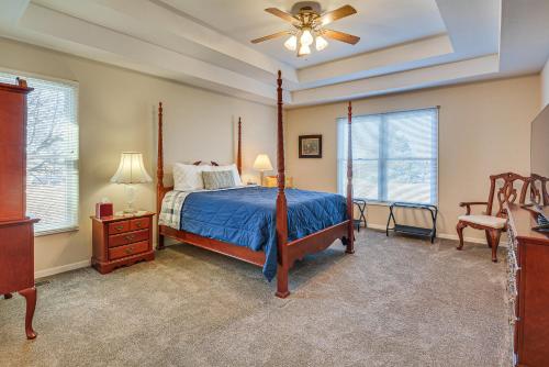 Un dormitorio con una cama y un ventilador de techo. en Stockton Home with Deck and Gas Grill about 1 Mi to Lake!, en Stockton