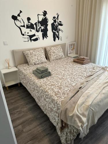 a bedroom with a bed with a white comforter at Alojamento Gândara in Praia de Mira