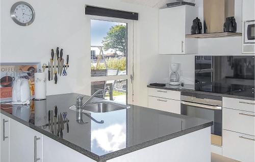 a white kitchen with a sink and a window at Awesome Home In Haderslev With Wifi in Kelstrup
