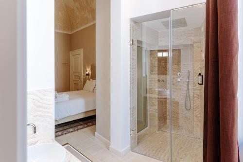 a bathroom with a shower with a glass door at Aeris Suite & Relax in Polignano a Mare