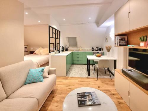 un salon avec un canapé et une chambre avec une cuisine dans l'établissement Luxury flat with amazing view on Eiffel Tower, à Paris