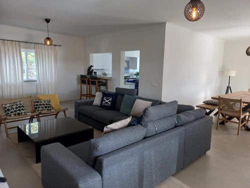 a living room with a couch and a table at Casa Tin Tin in Moncarapacho