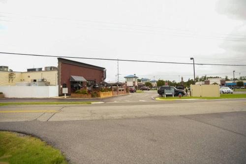 an empty street in a small town with cars parked at Modern Beachside Bliss: 2 Bed/2 Bath Condo Haven in Rehoboth Beach