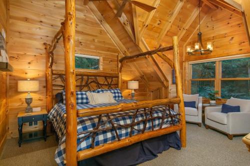 a bedroom with a bunk bed in a log cabin at Dreamy Mountain Getaway~Hot Tub~Old Oak Lodge in Waynesville