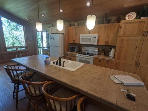 a kitchen with a large kitchen island with a sink at Hanging Rock Get Away in Bigfork