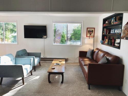 a living room with a couch and a coffee table at Woods Bay Get-A-Way in Bigfork
